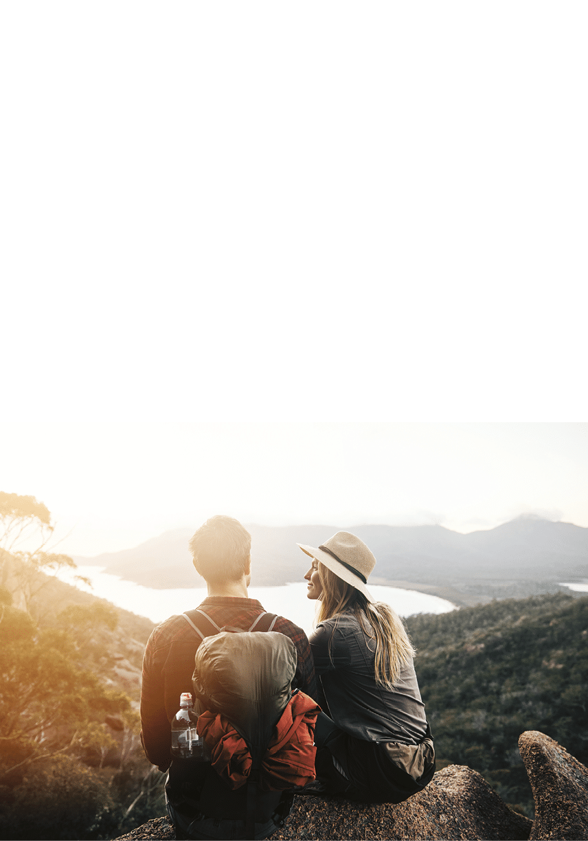 Shot of a young couple hiking the mountains in the morning