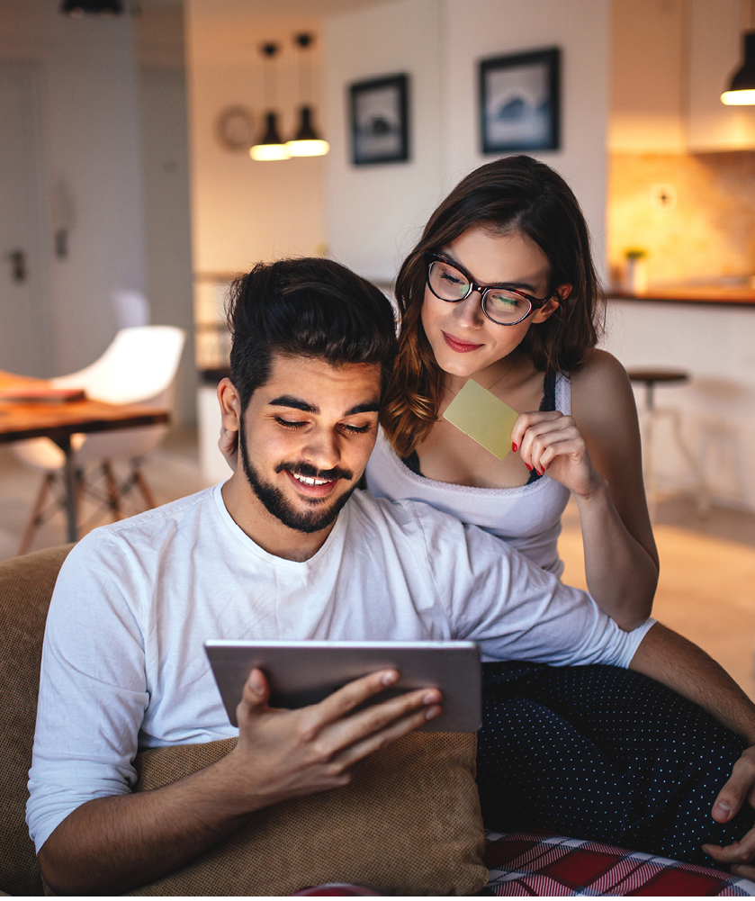 Photo of a young couple shopping online over digital tablet 