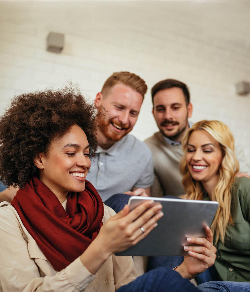 Group of friends holding a tablet